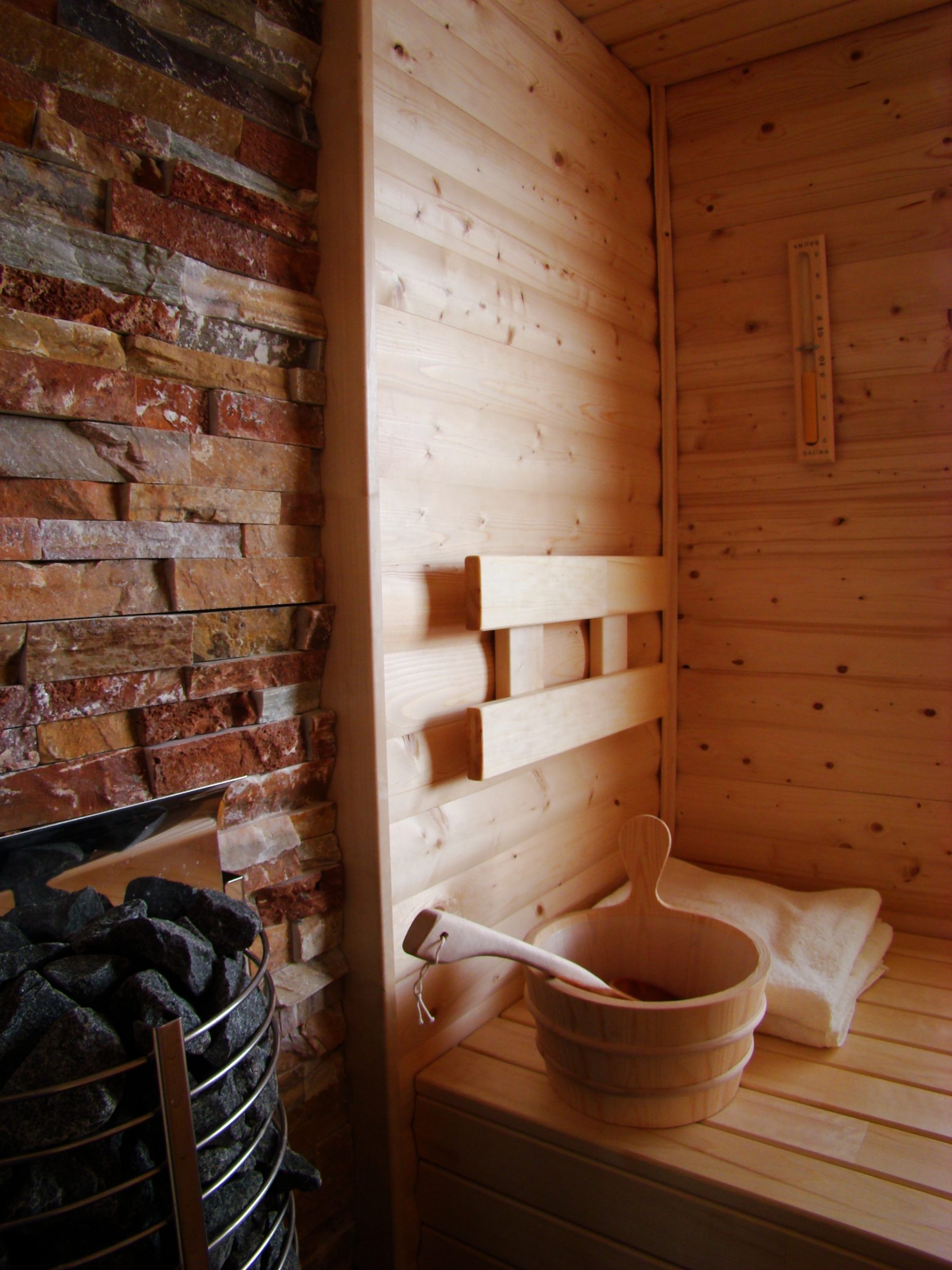 Natuursteenstrips Oranje Kwartsiet. Toegepast in een particuliere sauna.