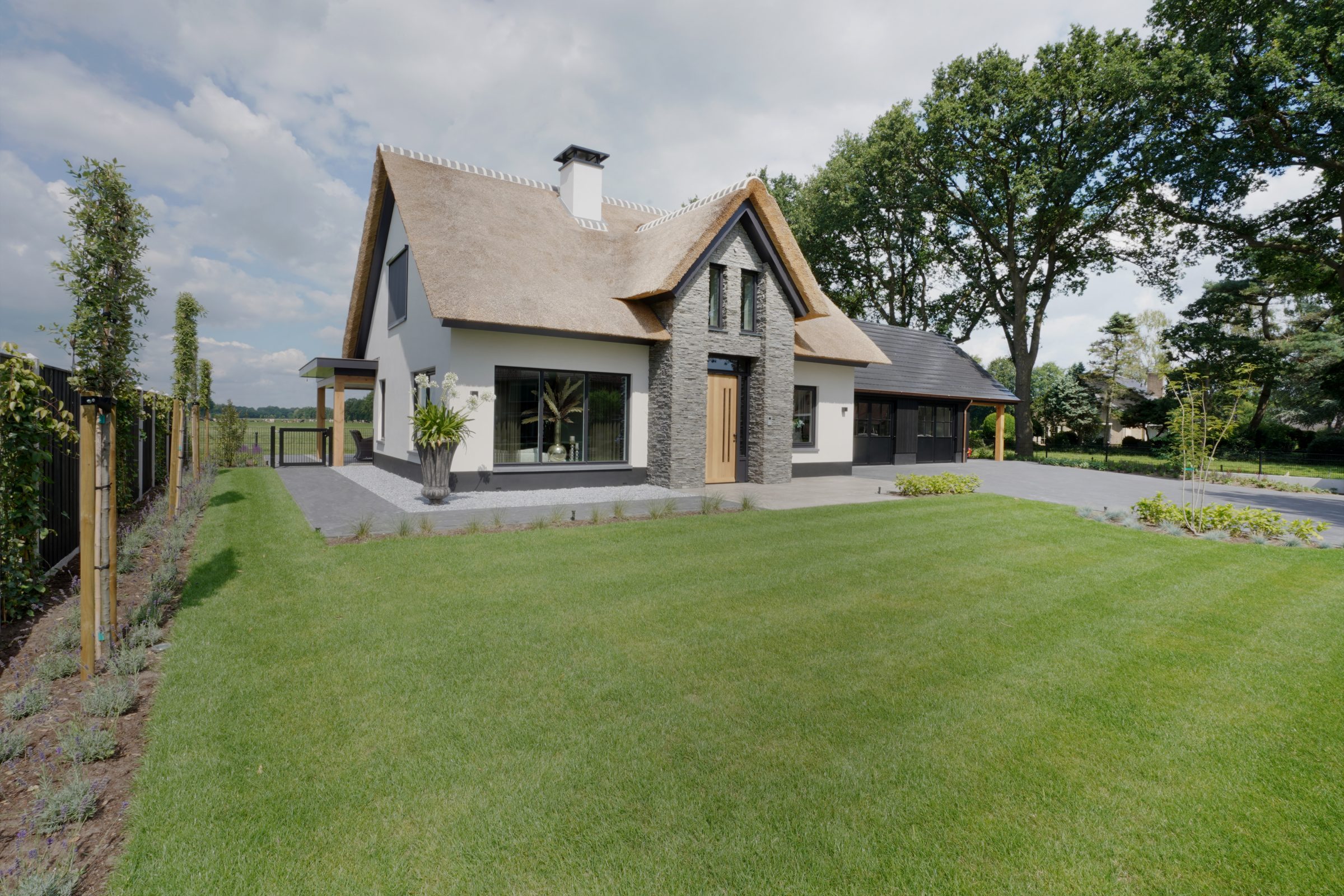 Natuursteen gevel, ontwerp door DBL Architecten - rieten kap